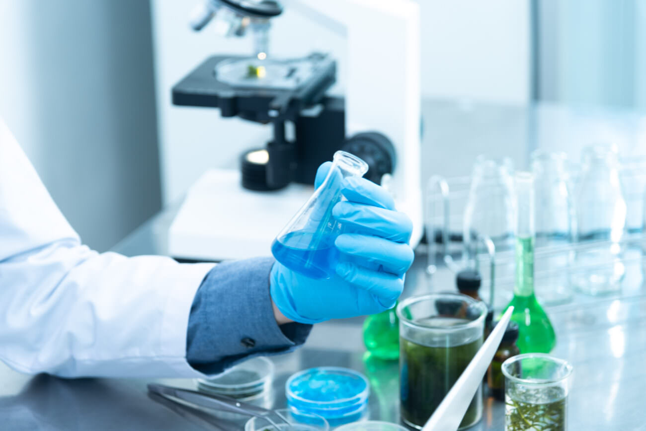 Scientist working on a vaccine in a lab with colorful test tubes